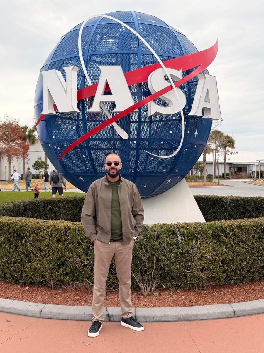 Gleidson Andrade em frente ao globo com o logotipo da NASA, a agência espacial dos Estados Unidos